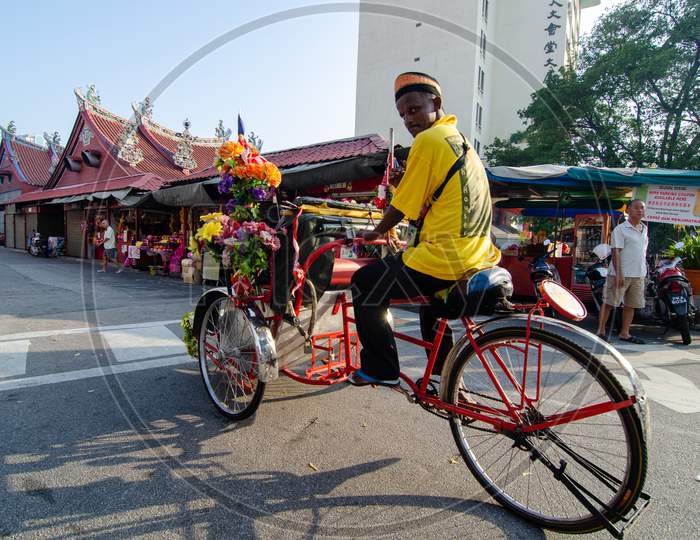 Rickshaw Driver At The Street Near The Goddess Of Mercy Temple