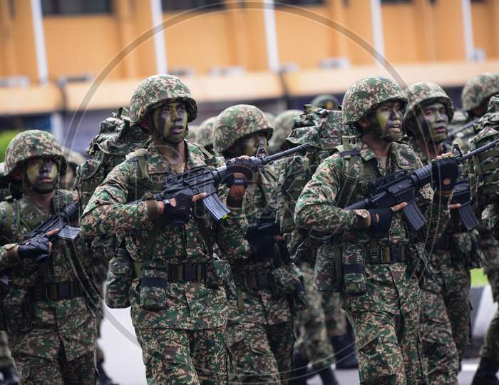 Soldiers Carry Gun During Merdeka Parade