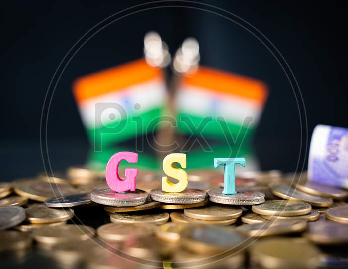 Gst Letters Placed On Coins With Indian Flag And Currency Note As Background - Concept Of Indian Good And Service Tax Collection.