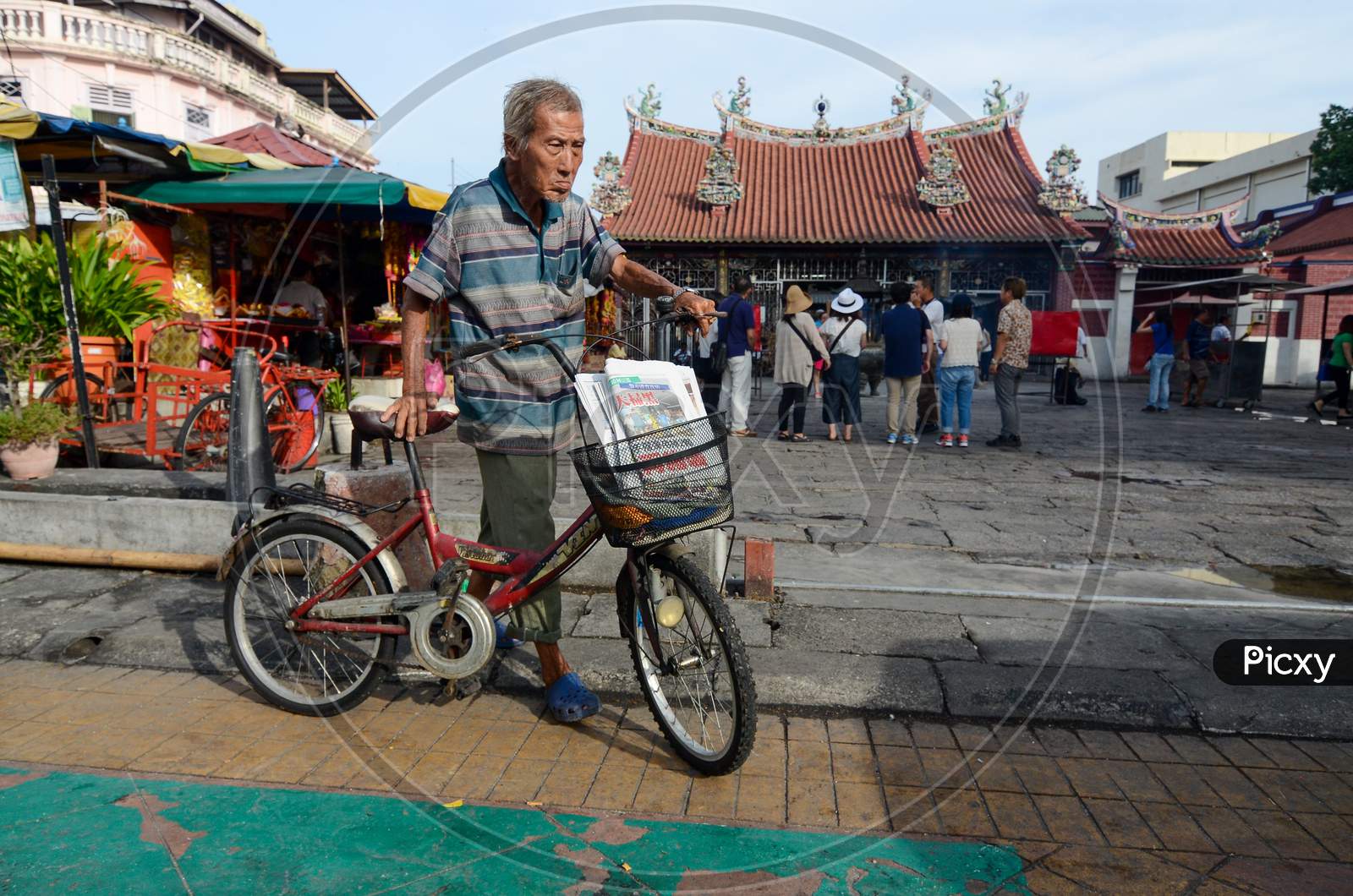 A Man Cycle At The Goddess Of Mercy Temple