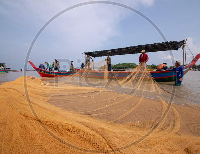 Fishermen Repair Fishing Net