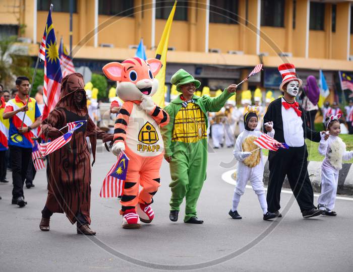 Mascot Hold Malaysia Flag During Independence Procession