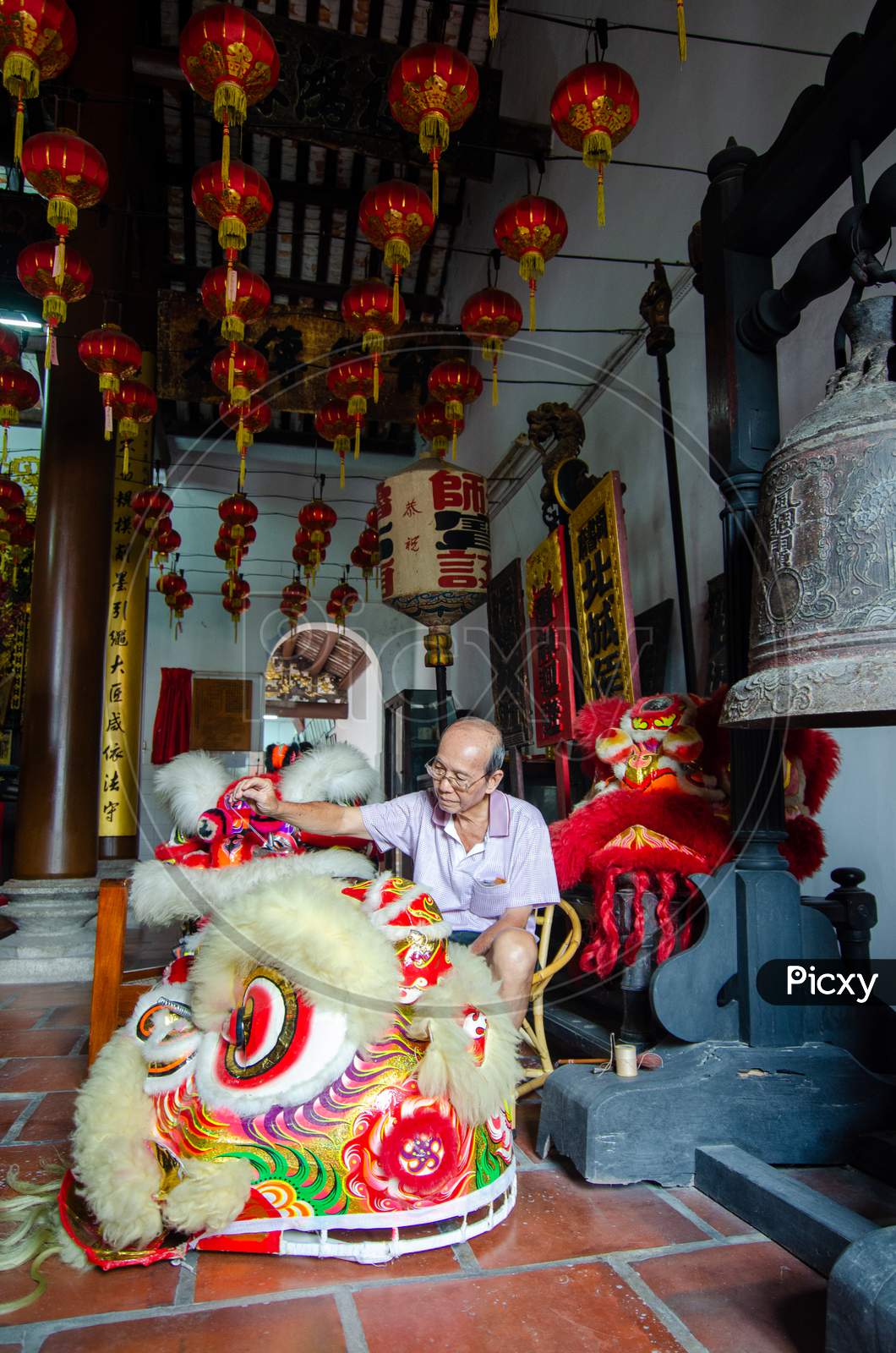 A Elder Repair The Lion Dance By Sewing