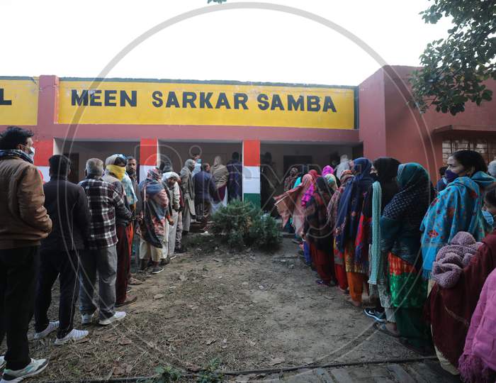 Villagers wait in queues to cast their votes during the second phase of the District Development Council (DDC) elections at Meen Sarkar Sambha in Jammu, Tuesday, Dec. 1, 2020.