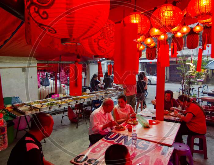 Chinese People Eat Vegetarian Food At Temple Decorated With Red Lantern