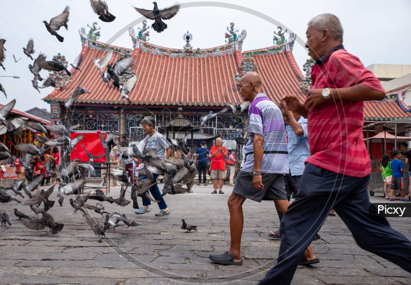 Old Man Run At In Front Of Chinese Temple