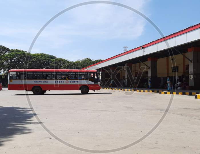 Closeup of KSRTC Bus Stand and Building with Buses pickup and drop of passengers in a station.