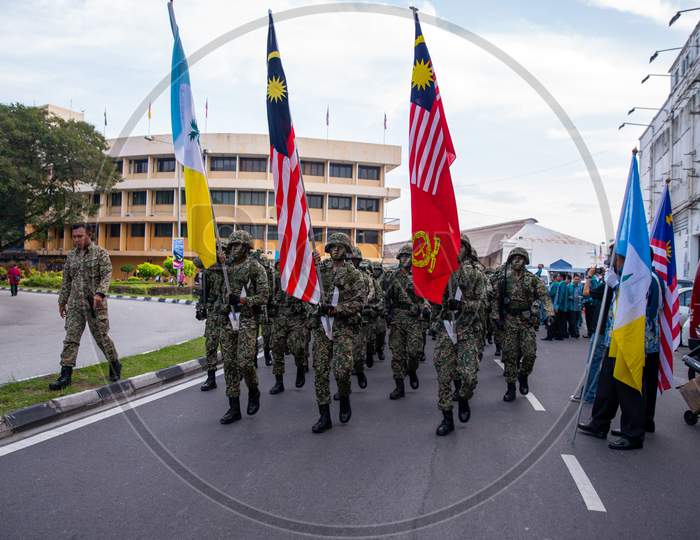 Soldier Hold The Malaysia Flag During Merdeka Procession