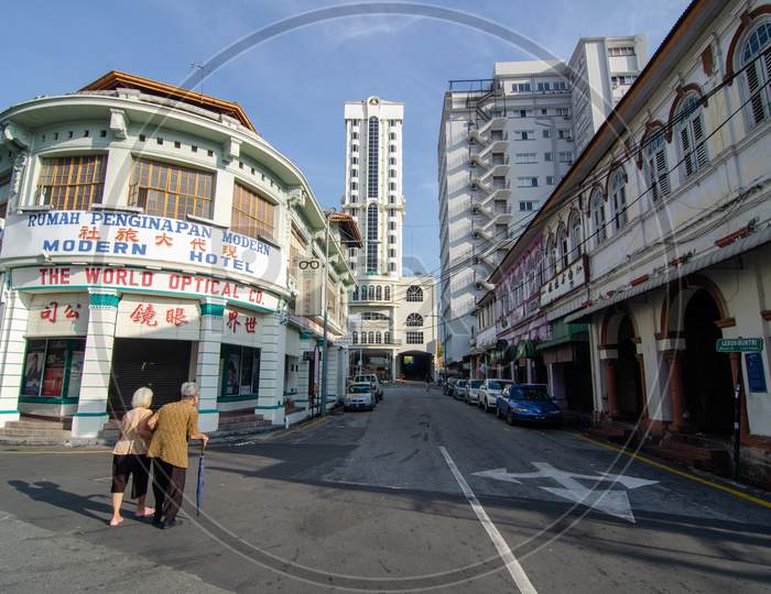 Two Elderly Women Walk Together At Street