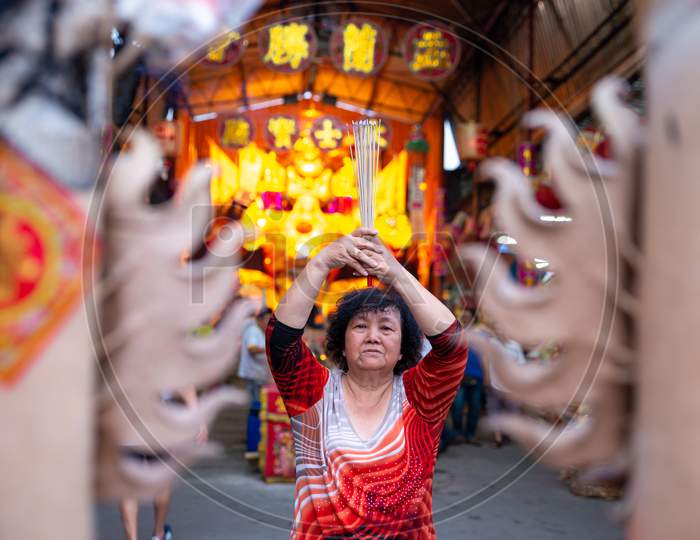 Chinese Woman Pray With Burn Joss Stick During Hungry Ghost Festival