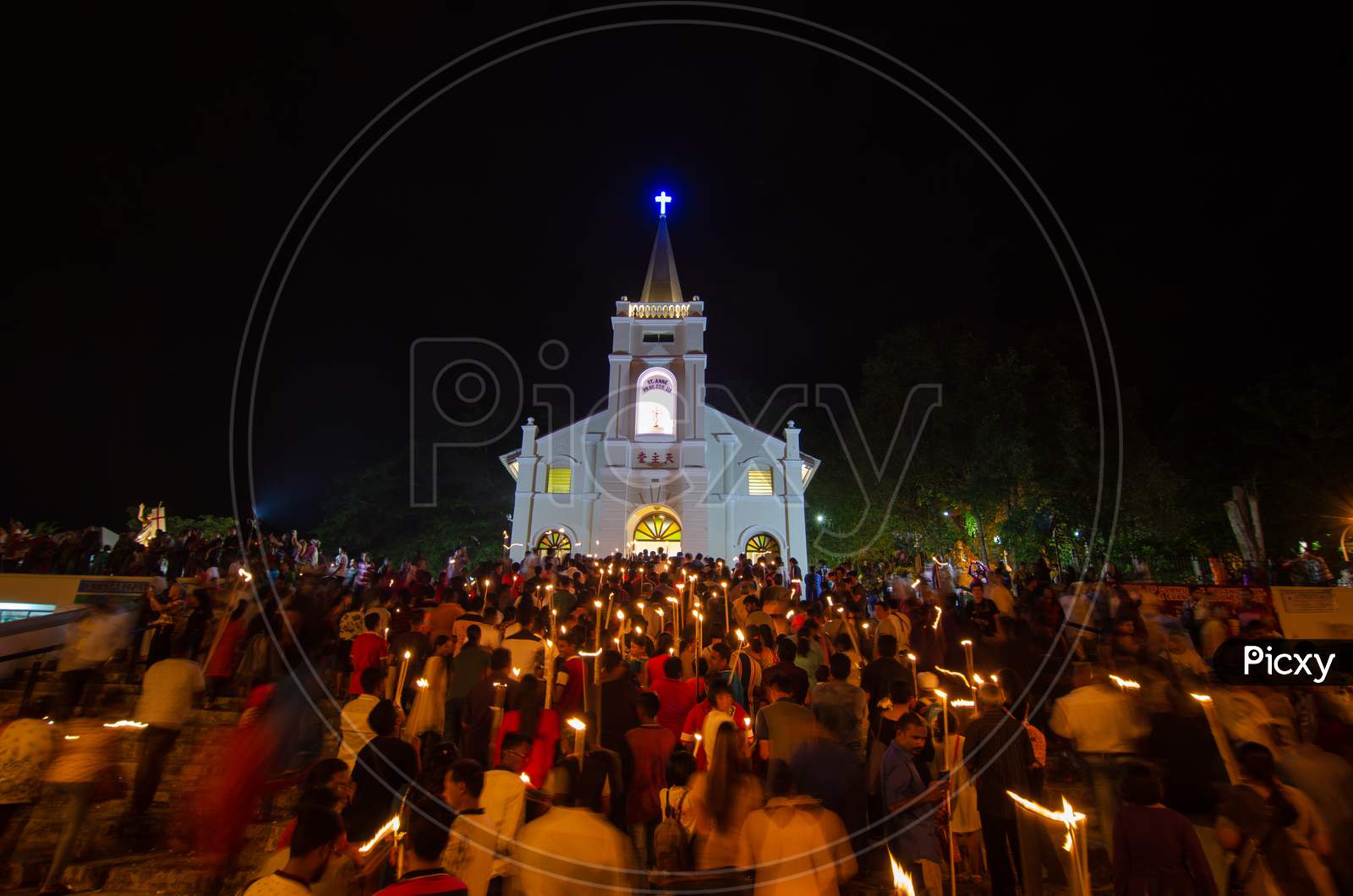 Devotees Hold The Candle And Walk Into The Church At Night During St Anne Feast