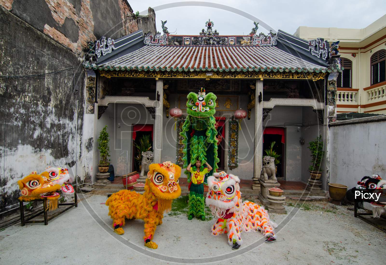 A Lion Dance Stack And Stand In Front Of Chinese Temple