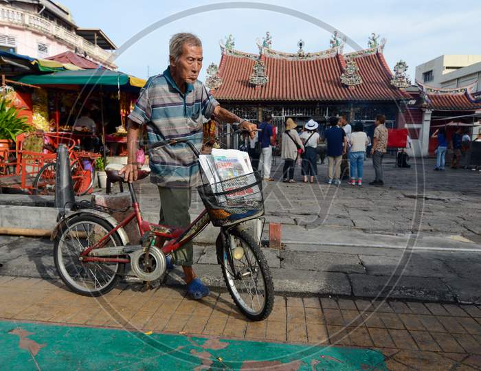 A Man Cycle At The Goddess Of Mercy Temple