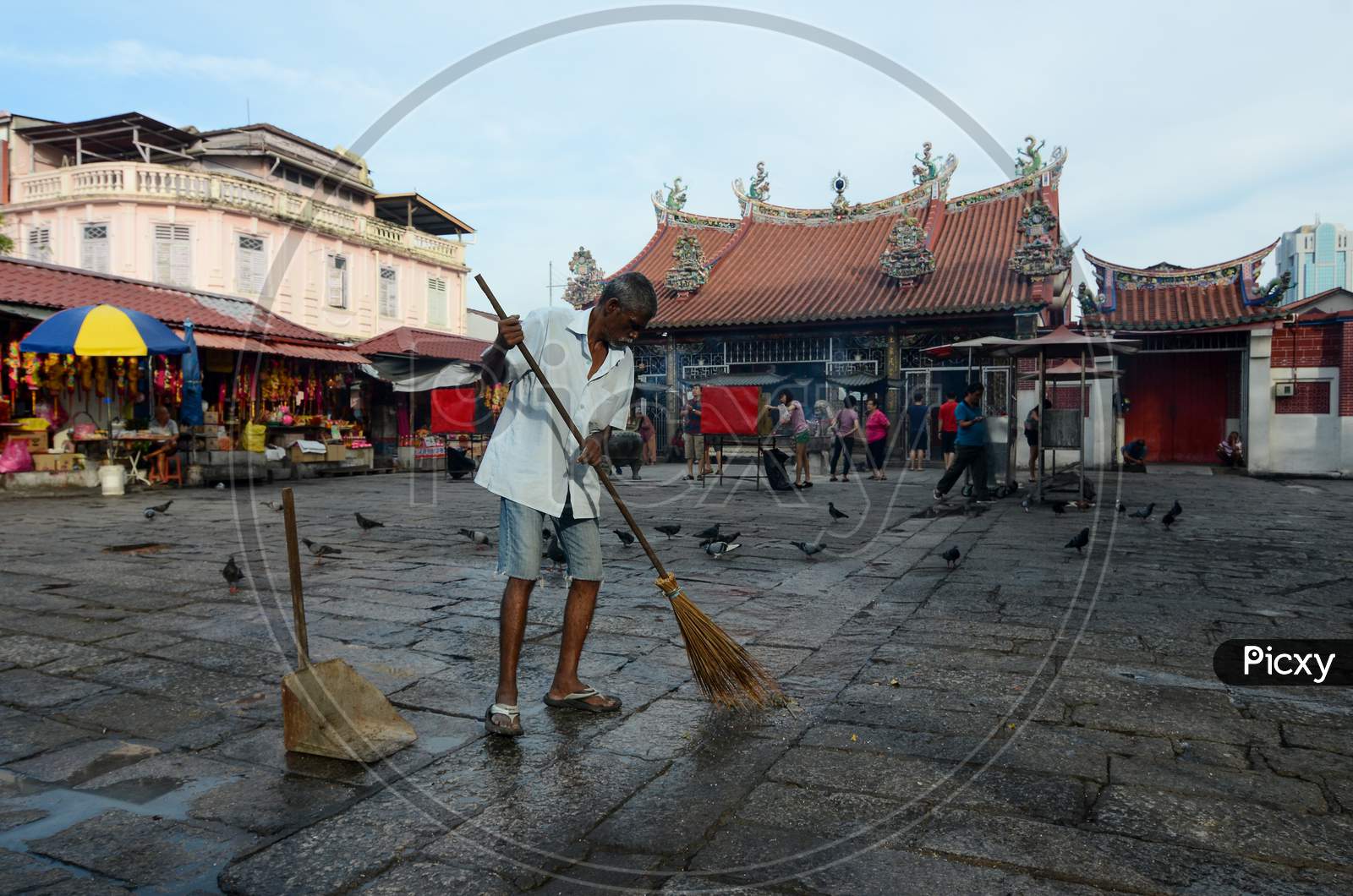 A India Man Clean The Floor At Goddess Of Mercy Temple
