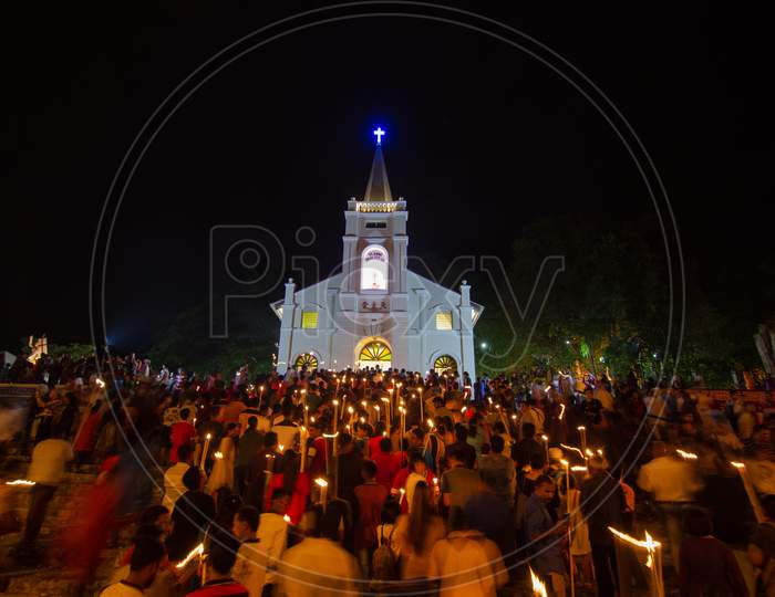 Devotees Hold The Candle And Walk Into The Church At Night During St Anne Feast