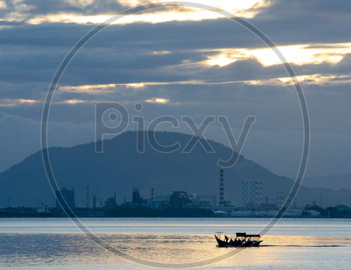 Fishing Boat With Anglers On The Journey To Sea. Background Is Cherok Tokkun Hill