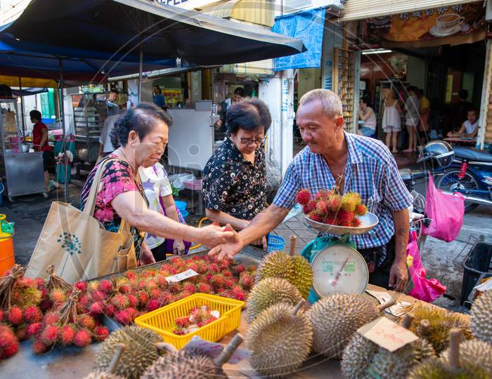 Hawker Sell Durian And Rambutan At Stall