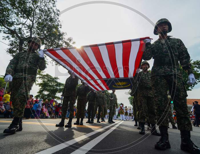 Low Angle Soldiers Carry Large Malaysia Flag Together