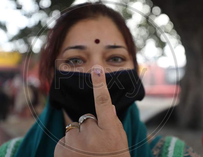 Villager woman show their fingers marked with indelible ink after casting their votes during the second phase of the District Development Council (DDC) election at Meen Sarkar Sambha in Jammu, Tuesday, Dec. 1, 2020.