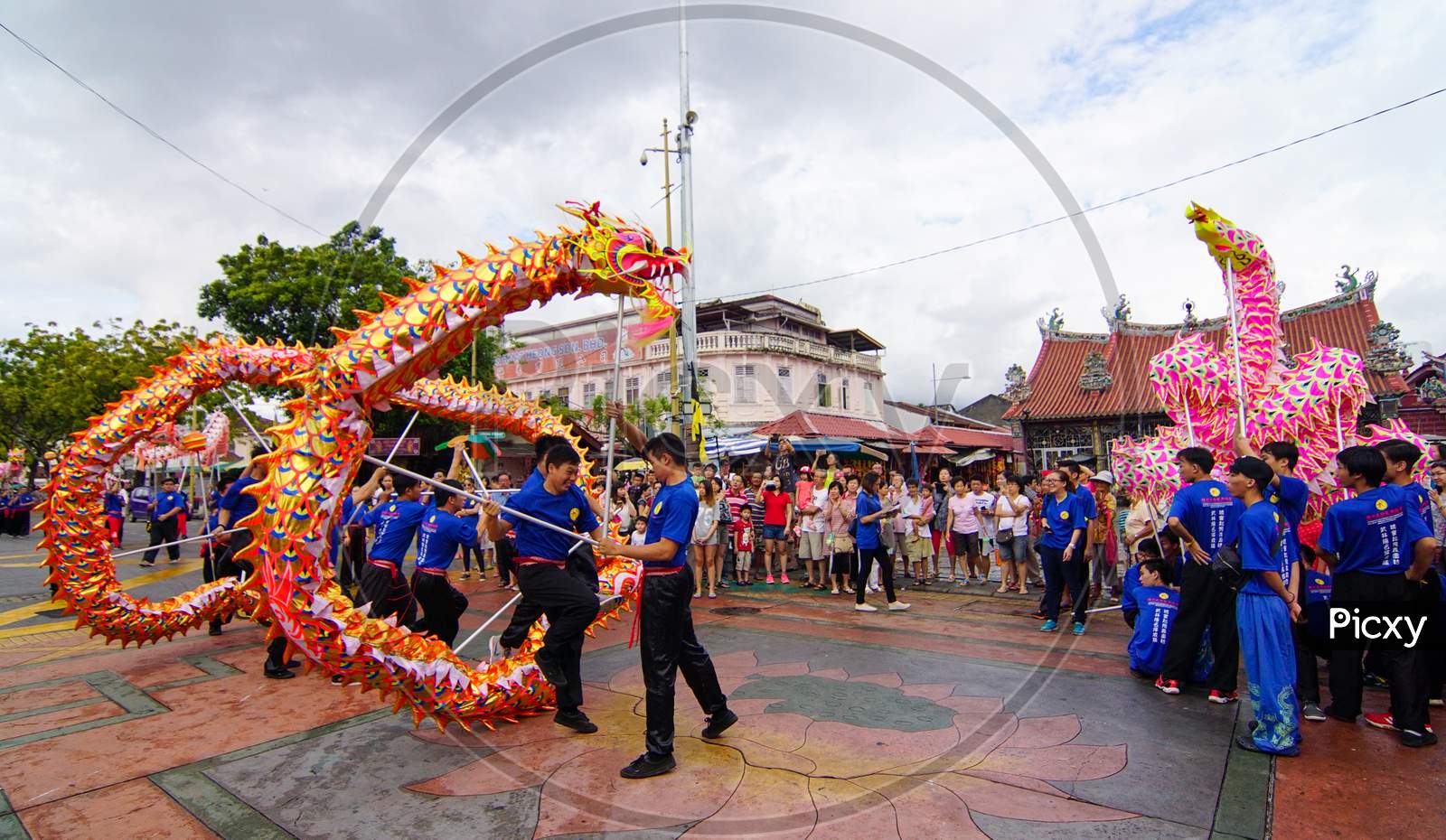 Group Of Man Perform Dragon At Street In Front Goddess Of Mercy Temple