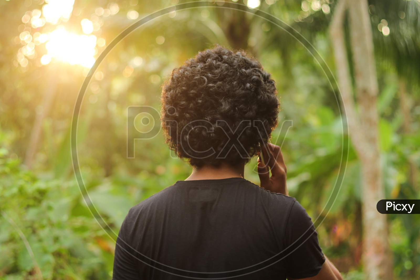 young man holding his smartphone over his ear