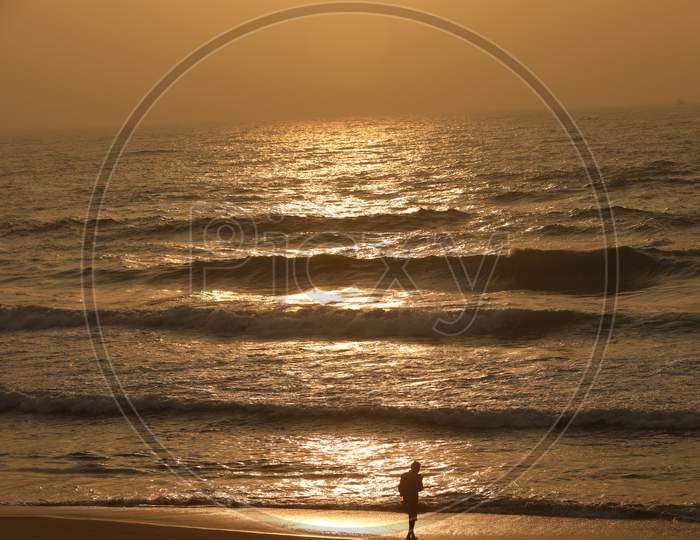 Silhouette of Old Man at Beach