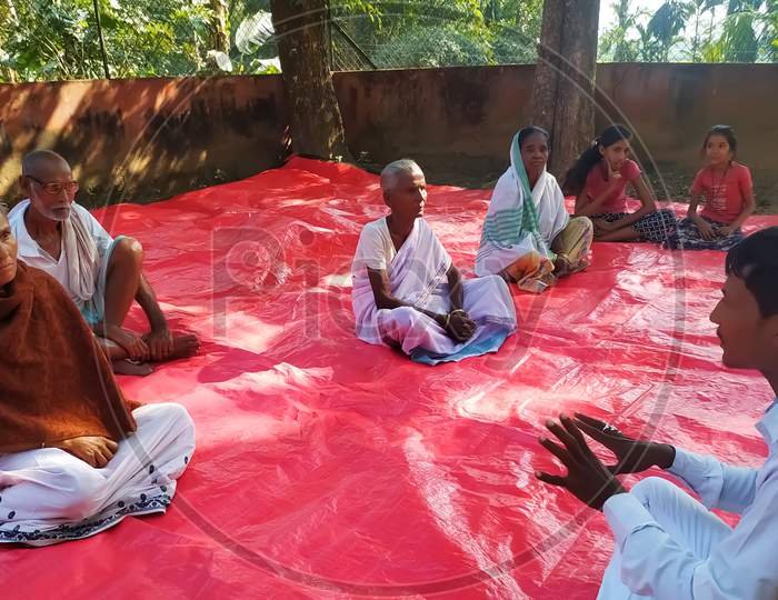 Yoga instructor discussing with local people of a community health center