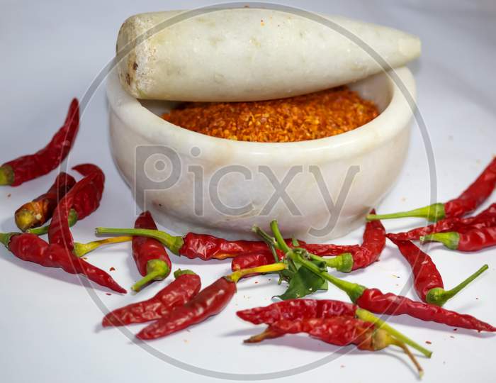 red hot chilli peppers and its powder in motor pestle