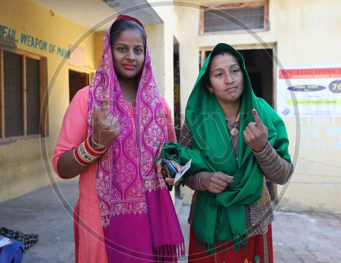 Voter shows her finger marked with indelible ink after casting her vote for the Fifth phase of District Development Council (DDC) election, at Phalya Mandal Village outskirts in Jammu.10,Dec,2020.