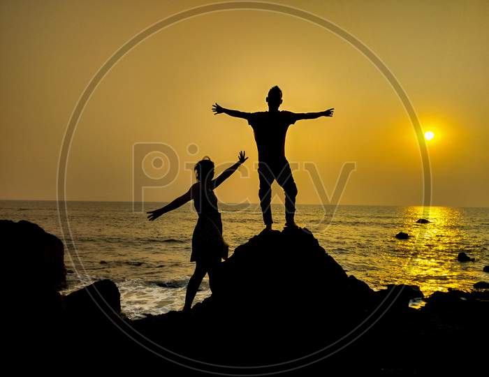 Silhouette figure of man and woman in sunset