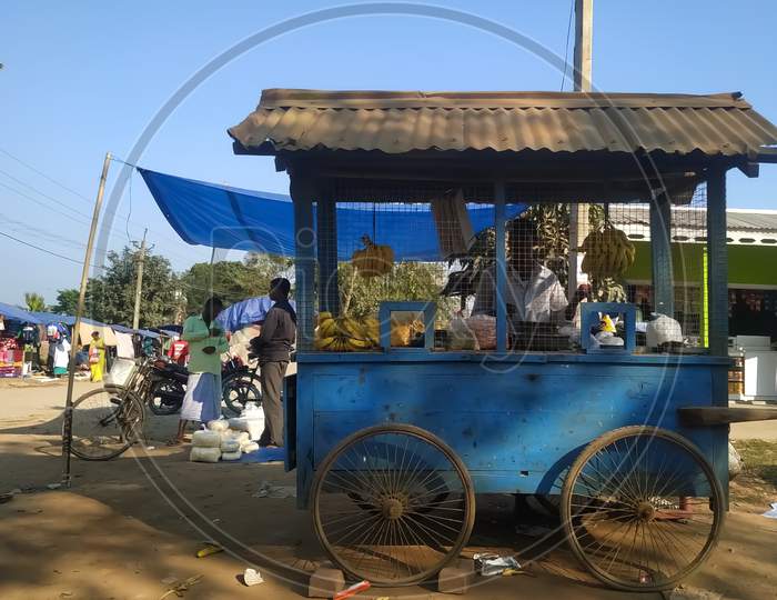 A movable wheeled vending cart in a rural market