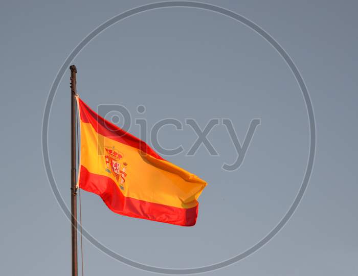 Spain Flag With A Blue Sky