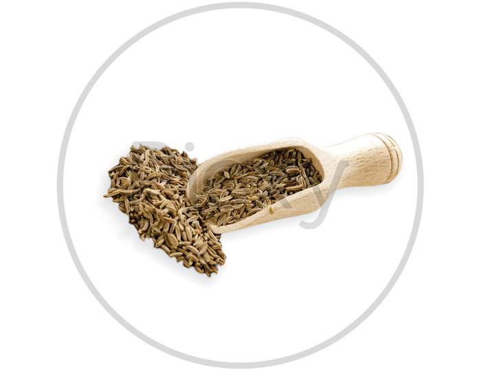 Food ingredients heap of cumin in a wooden scoop, on white background