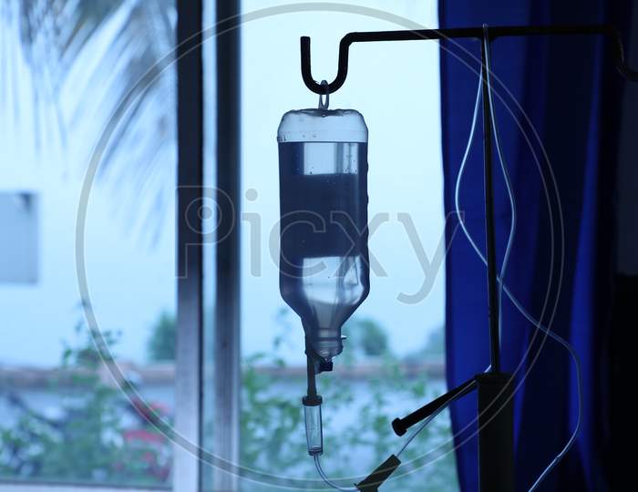 saline bottle hangs on hook in hospital