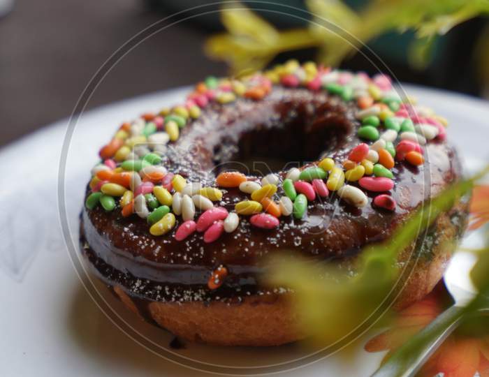 Chocolate donut with colorful sprinkling