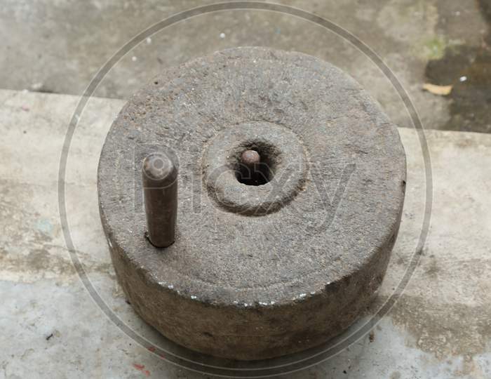 Vintage Stone Grinder at rural home