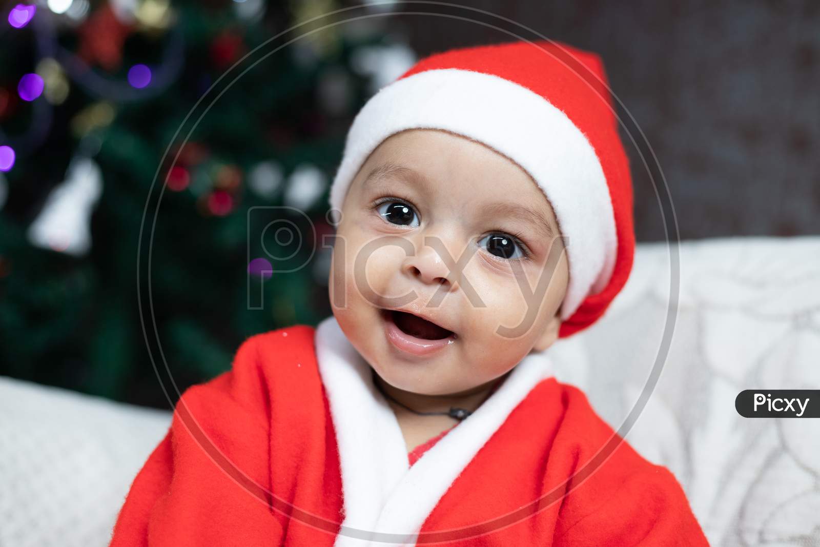 Smiling baby in Santa dress