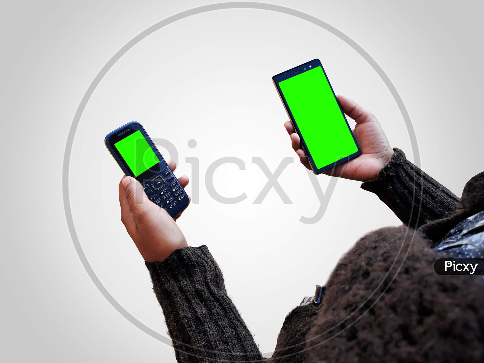 Female Holding Two Smart Phones Mock Up In Hands With Green Screen Isolated