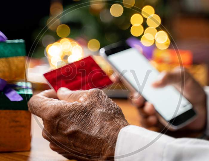 Selective Focus On Hand, Close Up Of Senior Man Hand Entering Card Details For Online Payment On Mobile - Concept Of Senior People Learning Or Using Ecommerce, Technology And Internet For Shopping.