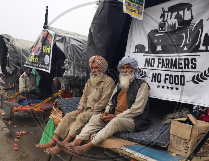 A farmer listens to a speaker along a blocked highway during a demonstration against the central government's recent agricultural reforms at the Delhi-Haryana state border in Singhu on December 11, 2020.