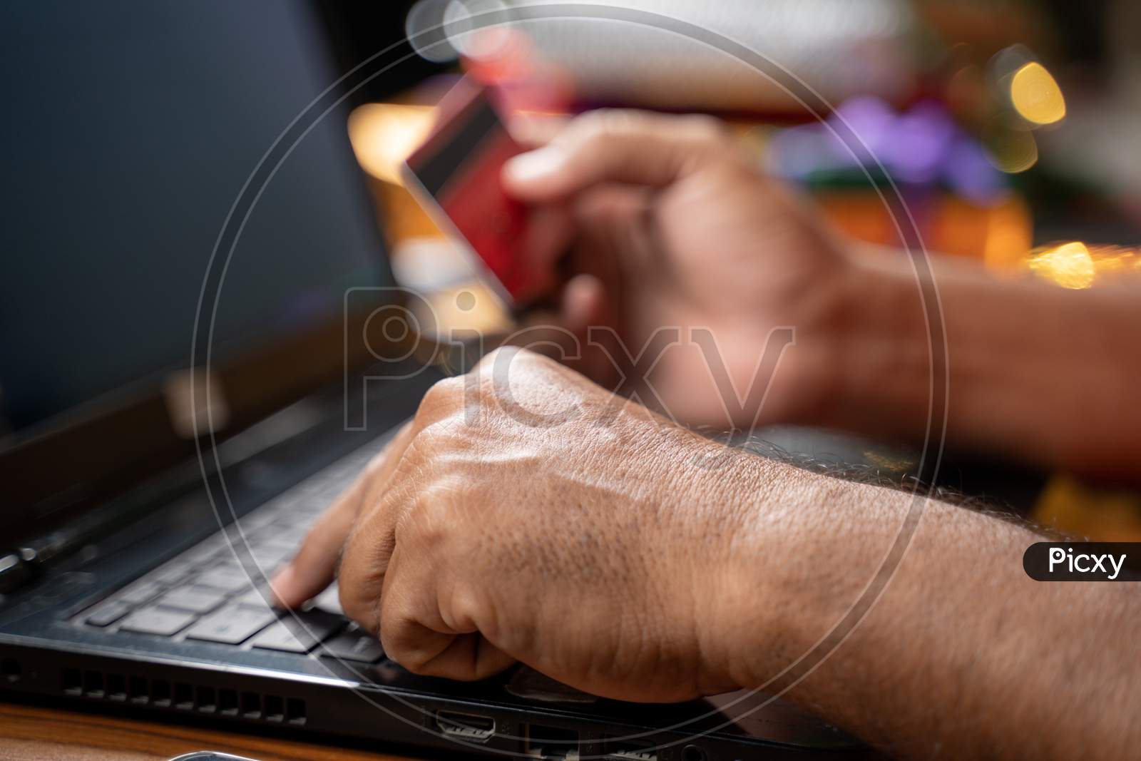 Close Up Of Old Man Hands Busy In Purchasing Or Doing Online Payment On Laptop During Holiday Seasonal Sale - Concept Of Senior People Using Ecommerce, Technology And Internet For Shopping On Laptop.
