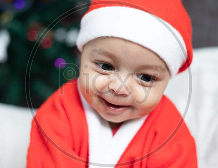 Smiling baby in Santa dress