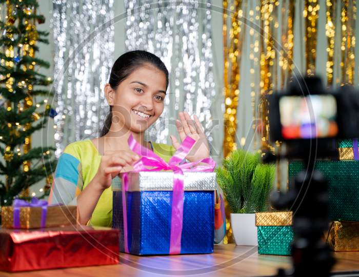 Girl Opening Gift In Front Of Camera During Christmas Eve - Concept Of Vlogging, Girl Got Gift Or Present From Subscribers During Holyday Season.