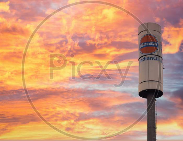 Signage Of Indian Oil Petrol Pump Shot Against A Monsoon Clouds And Blue Sky Showing India'S Largest Petroleum Manufacturer And Petrol Pump Owner