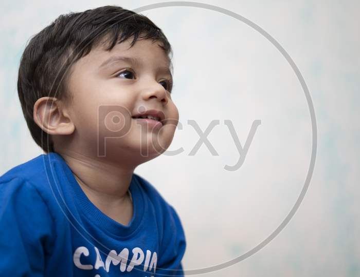 Portrait Of A Young Indian Infant Kid With Innocent Eyes.