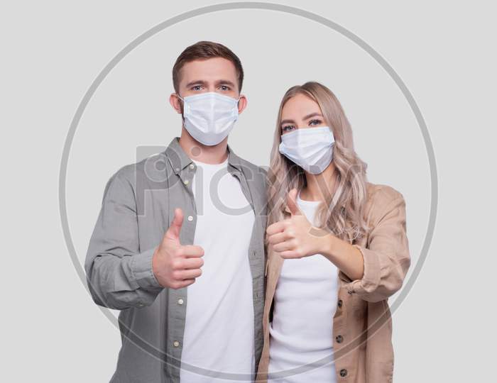 Couple Wearing Medical Mask Showing Thumb Up Isolated. Man And Woman Hugging, Lovers, Friends, Couple, Virus Concept
