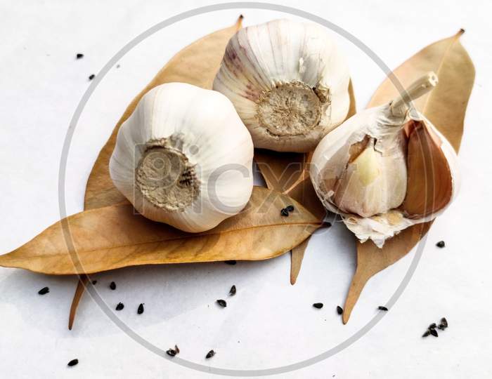 Close-Up Died Garlic,Bay-Leaf,Black Cumin On A White Background.Copy Space For Text.