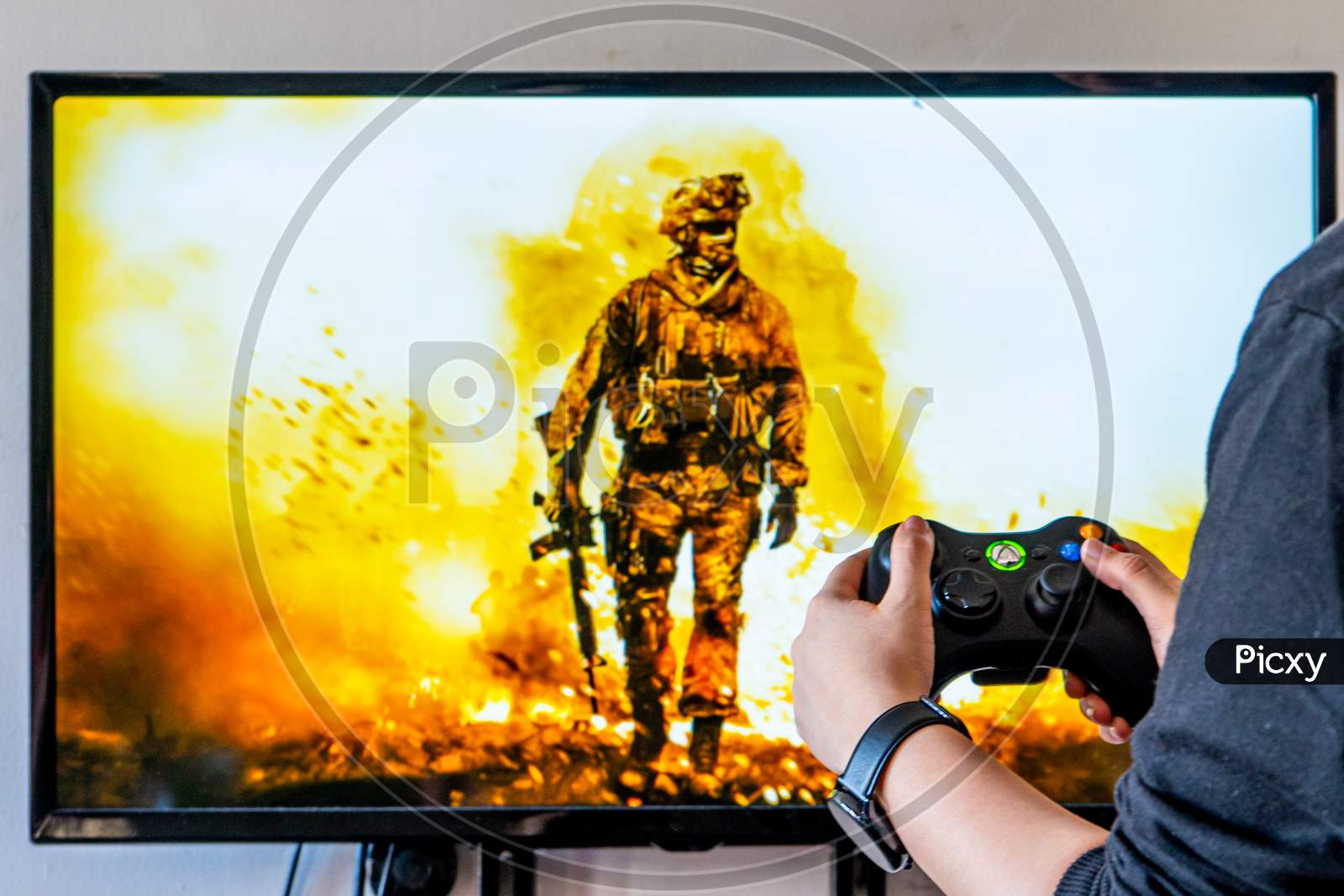 Woman Holding A Xbox Controller And Playing Popular Video Game Call Of Dutyon A Television And Pc