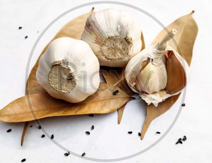 Close-Up Died Garlic,Bay-Leaf,Black Cumin On A White Background.Copy Space For Text.