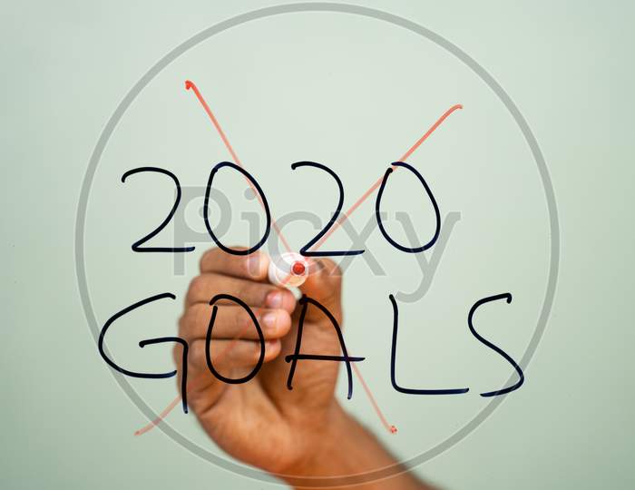 Scratched Out 2020 Goals Due To Coronavirus Or Covid-19 Pandemic On Glass - Concept Of Failed 2020 Goals.